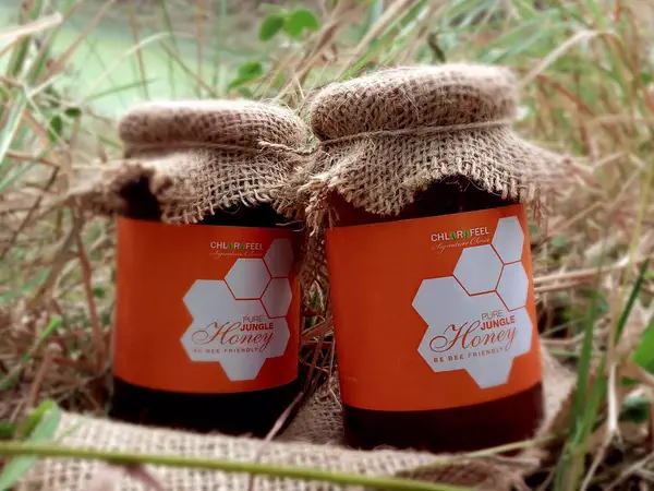 Jars of Sobuj Thikana pure jungle honey wrapped in jute