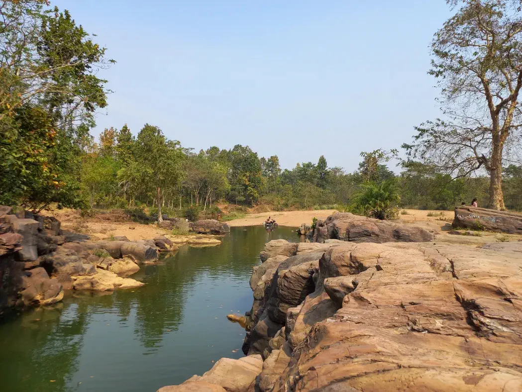 Rocky pools and forest at Ghaghra Waterfall
