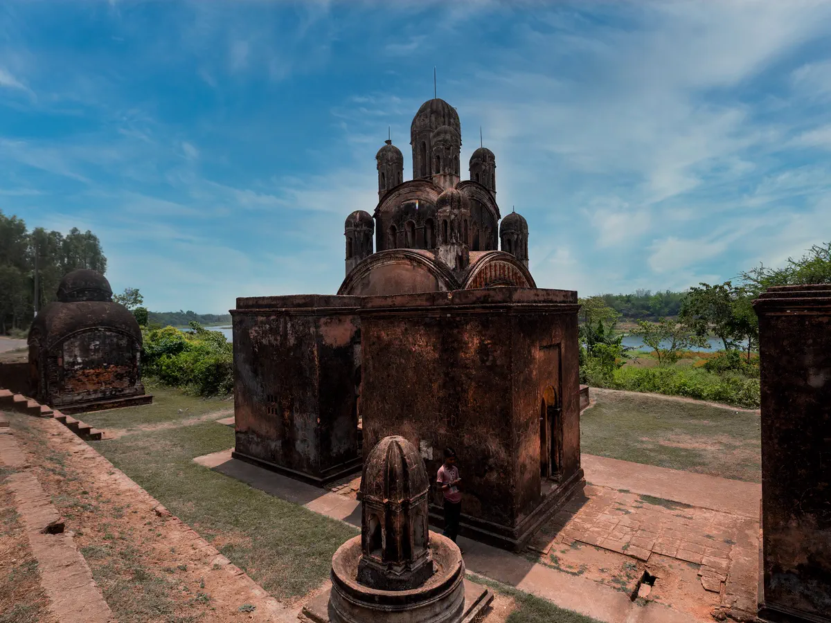 Old stone temple at Mondirmoy Pathra under a blue sky
